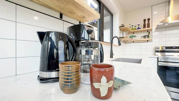 A kitchen with a coffee maker, a kettle, and a mug on the counter. - Poplar Wood, New Sauna! (Bayfield)