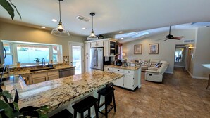 A modern kitchen with granite countertops, stainless steel appliances, and pendant lighting. - Exceptional! Remodeled 3Bd / 2Ba with GIANT Private Pool and Covered Patio (Phoenix)