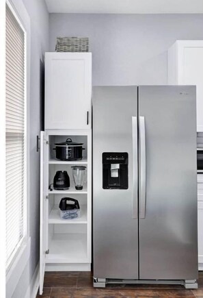 Enjoy cooking in this fully equipped kitchen with a refrigerator, water dispenser, and pantry.