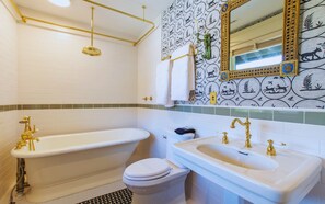 A bathroom with a bathtub, toilet, and sink, all with gold fixtures. - Whole 9BR Historic Mansion, Weddings & Events (Lincoln)
