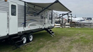 A mobile home with a covered porch and a ramp for accessibility. - Lake St Clair Waterfront (Chesterfield)
