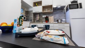 A kitchen counter with breakfast items, a microwave, and a refrigerator. - Al Castello-Independent house- Holiday home in Catania (Catania)