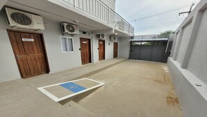 A building with multiple doors, air conditioning units, and a wheelchair-accessible ramp. - Hotel Manaus - Dom Pedro (Manaus)