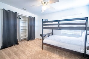 A bunk bed room with a ceiling fan, a walk-in closet, and a window with blinds. - Luxe Resort Style Home Stunning 8 Beds with Pool (El Cajon)