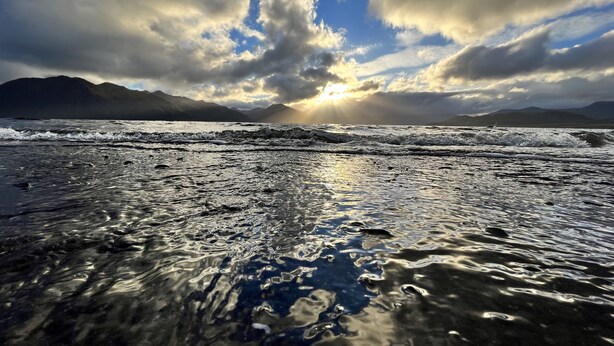 A beach with waves and mountains in the background. - Saltery Adventures Remote Loft Cabin (Kodiak)