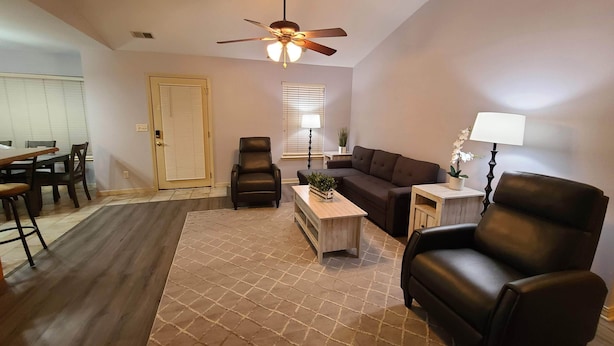 A living room with a sofa, armchairs, a coffee table, and a ceiling fan. - Heart of Branson #2 (Branson)
