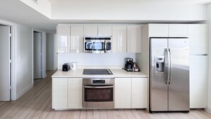 A modern kitchen with stainless steel appliances, a built-in oven, and a refrigerator. - Exclusive 3 bedrooms apartment w Amazing View (Hallandale Beach)