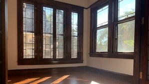 A room with large windows and wooden flooring. - Walk to Beach Lake of Michigan, Lake Park, Eastside Milwaukee, Sleep 6, Parking (Milwaukee)