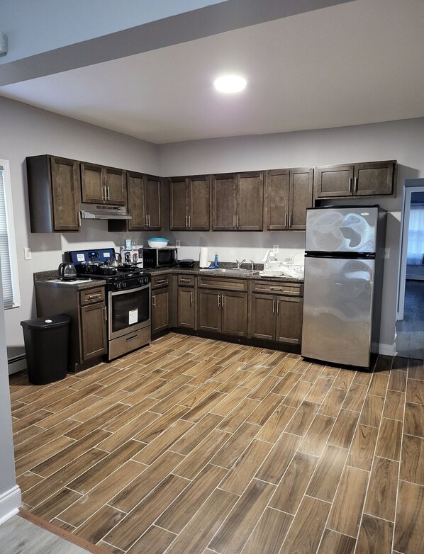 Enjoy cooking in this fully equipped kitchen with an oven, refrigerator, and ample counter space.