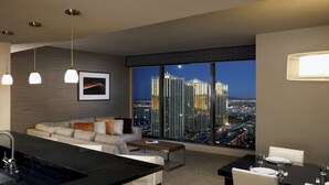 A modern hotel room with a kitchen, dining area, and a large window offering a city view. - Stay in Style at Elara Hilton's 2BR Suite During the Las Vegas Formula 1 Race. (Las Vegas)