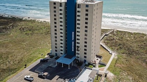 A high-rise building with a central blue section labeled "MUSTANG TOWERS".