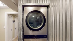 A compact, stainless steel laundry room with two large front-loading washing machines. - Modern Chalet w/ Serene Views and Jacuzzi Hot Tub- 15 Minutes to Okemo Mountain (Chester)
