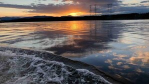A calm body of water reflecting a sunset with mountains in the background. - Beautiful Yacht on Catskill Creek (Catskill)