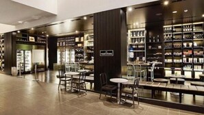 A modern food store with a variety of seating options and shelves stocked with products. - 26 levels above Hilton hotel - 2 bedrooms (Surfers Paradise)