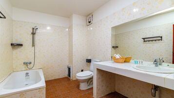 A bathroom with a bathtub, toilet, and sink.