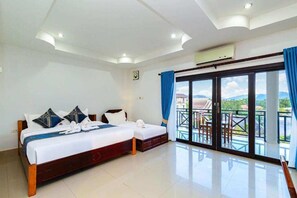 Family Room | Minibar, desk, laptop workspace, blackout drapes - Lisha Grand Riverside Hotel (Vang Vieng)