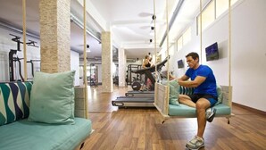 A modern gym with a treadmill, a pull-up bar, and a hanging rope swing. - Apartment Aloha Hill Club Marbella (Marbella)