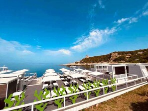 A rooftop terrace with multiple sun loungers and a view of the sea. - Housing of charme with rooftops balconies (Galatone)