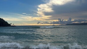 A coastal view with waves and a clear sky.