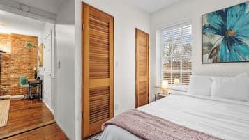 2 habitaciones, escritorio y tabla de planchar con plancha