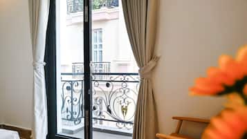 Deluxe Double Room, Balcony | Individually furnished, desk, laptop workspace, blackout drapes