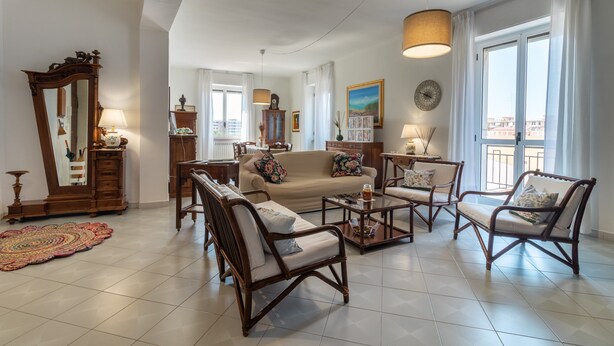 A living room with a sofa, armchairs, a coffee table, a mirror, and a lamp. - Apartment "Chicca Casa Vacanze" with Private Terrace & Wi-Fi (Bari)