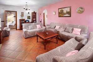 A living room with a sofa set, a coffee table, and a bookshelf.