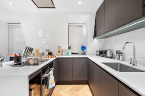 Enjoy cooking in this well-lit kitchen with a large island, oven, and microwave.