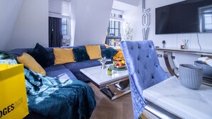 A modern living room with a sectional sofa, a coffee table, and a television. - Marble Arch Penthouse 73, Best Location! (Greater London)