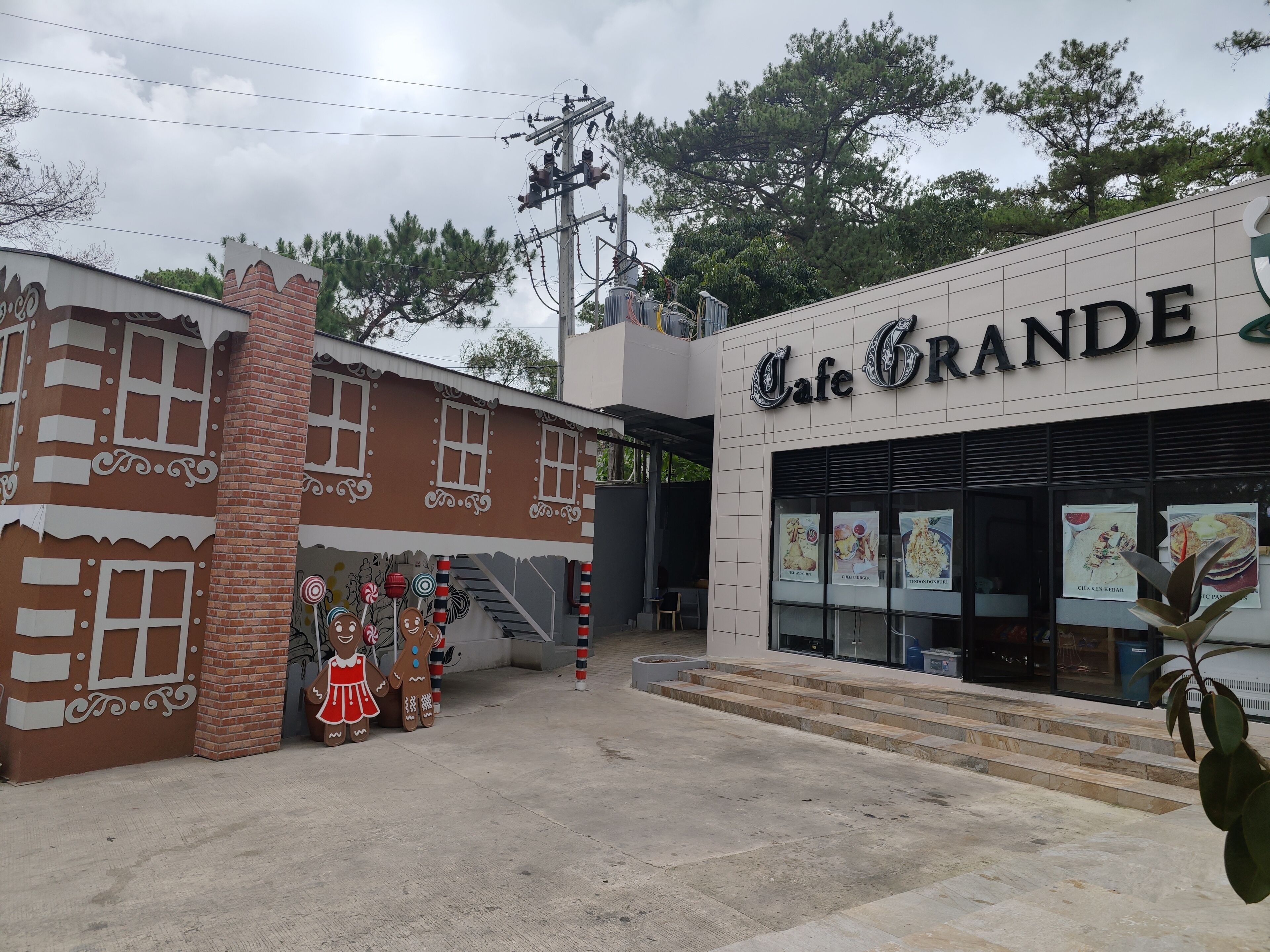 A building with a gingerbread house facade and a sign reading "Cafe Grande".