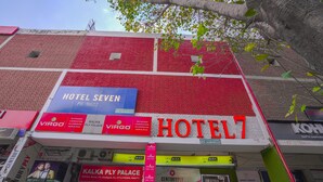 A building with a prominent red and white sign for HOTEL7. - Hotel Seven - Centre of City Chandigarh (Chandigarh)