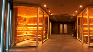 A hotel corridor with wooden paneling and glass doors, leading to rooms labeled "Lodge on LocI' LocI' LocI'". - The Beach House (Alexandria)