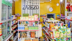 A grocery store interior with shelves stocked with various products, a clock on the wall, and a sign that reads "ZAZEZO". - Hotel O Zazezo Homestay Syariah (Tanjung Pinang)