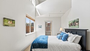 A bedroom with a bed, a window, and two wall-mounted pictures. - Newpark, Close to ski resorts and restaurants, Amazing Views, Private hot tub (Park City)