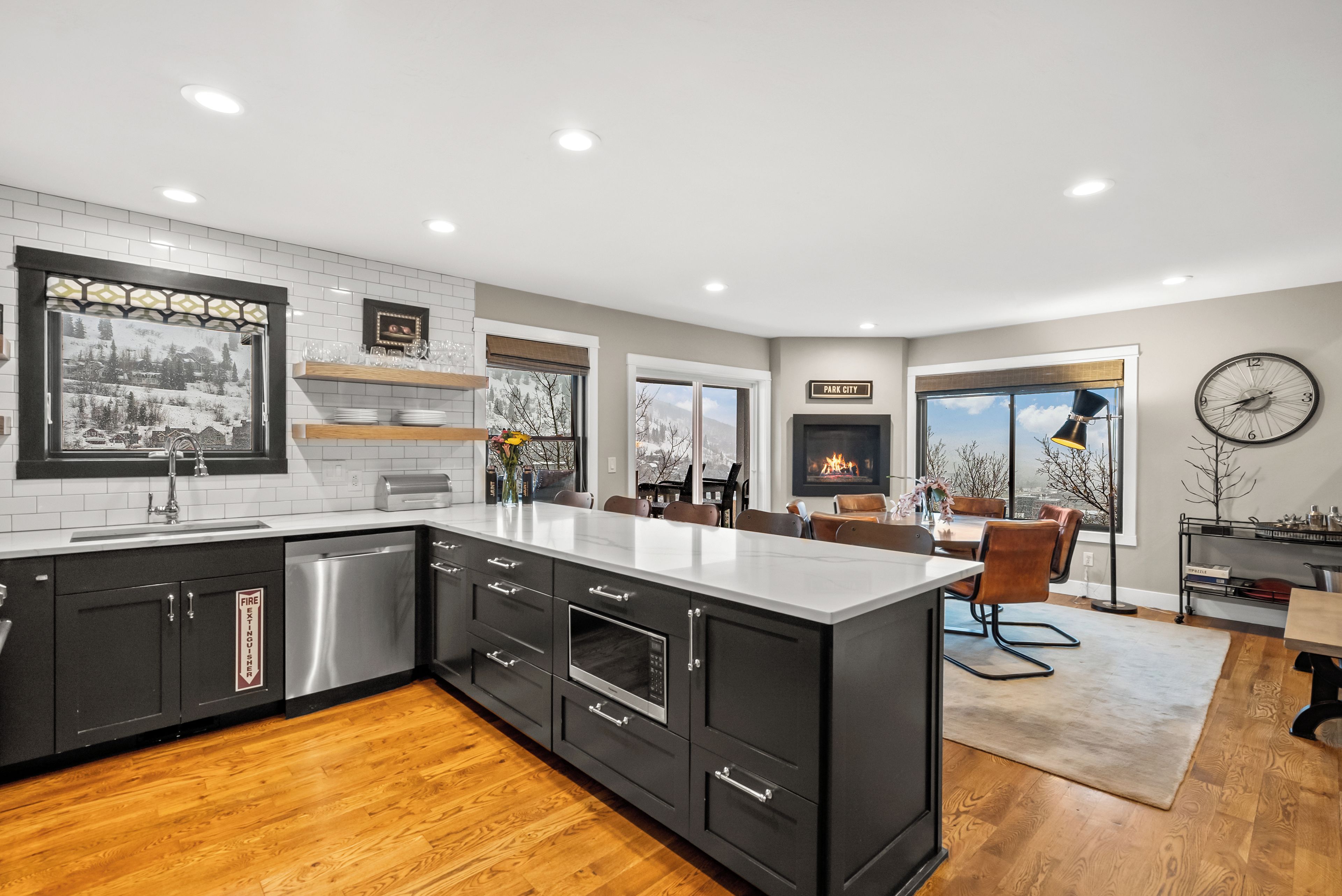 - Spacious open kitchen with sleek countertops and bar  
- Dining and living area flow together with mountain views  
- Fireplace adds warmth to gatherings after adventure
