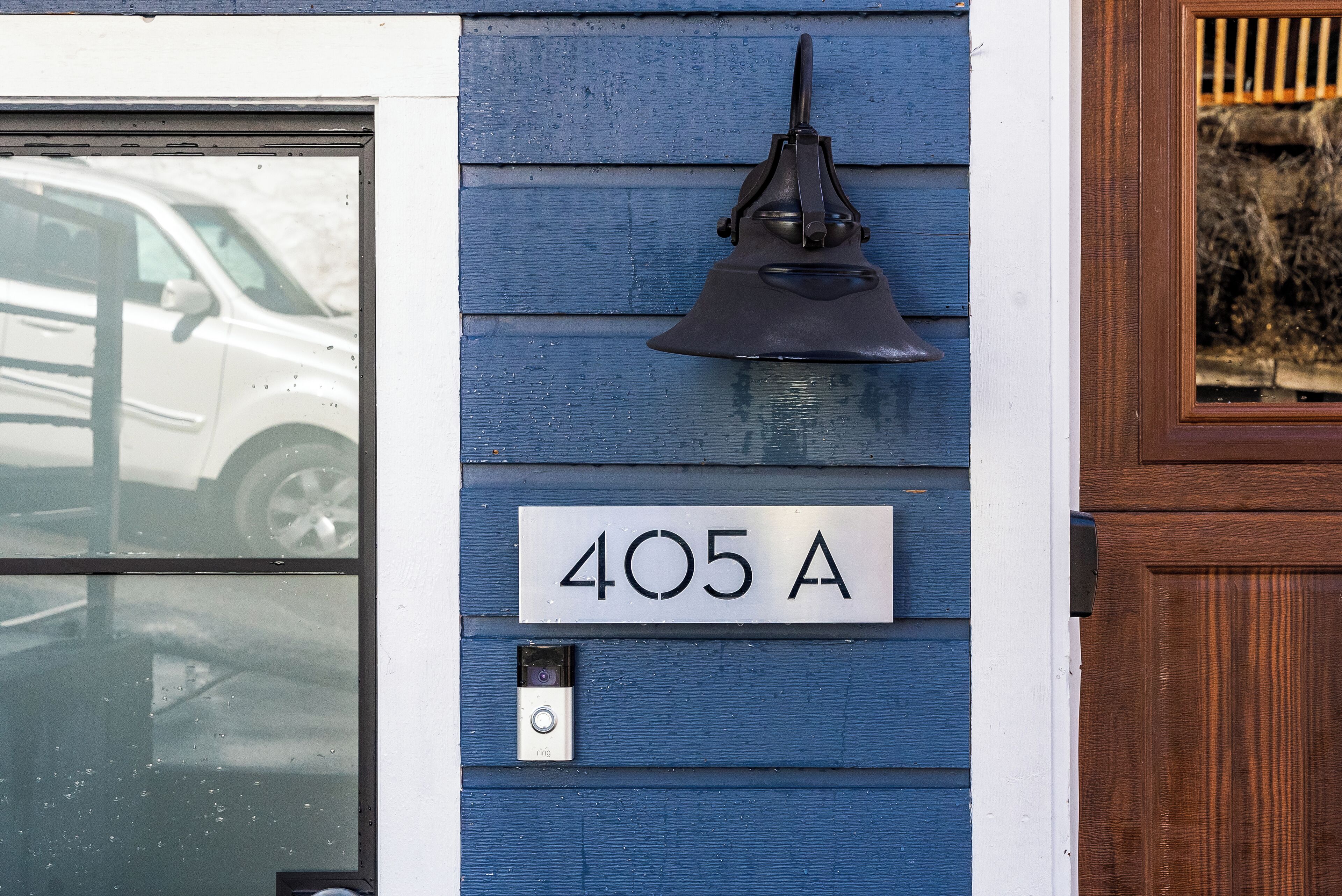A house number 405 A on a blue house with a black mailbox and a doorbell.