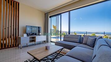 Deluxe Villa, Private Pool, Sea View | Living room | 40-inch Smart TV with cable channels, TV