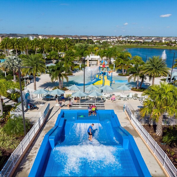 Relax by the pool surrounded by palm trees and a serene view.