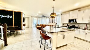 Enjoy cooking in this well-equipped kitchen with a large island and stainless steel appliances.
