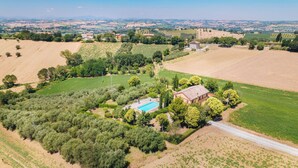 An aerial view of a rural property with a swimming pool, surrounded by fields and trees. - Italian Experience - Casa Bellavista (Ostra)