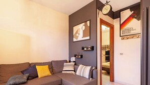 Una sala moderna con un sofá modular, un reloj y obras de arte en las paredes.