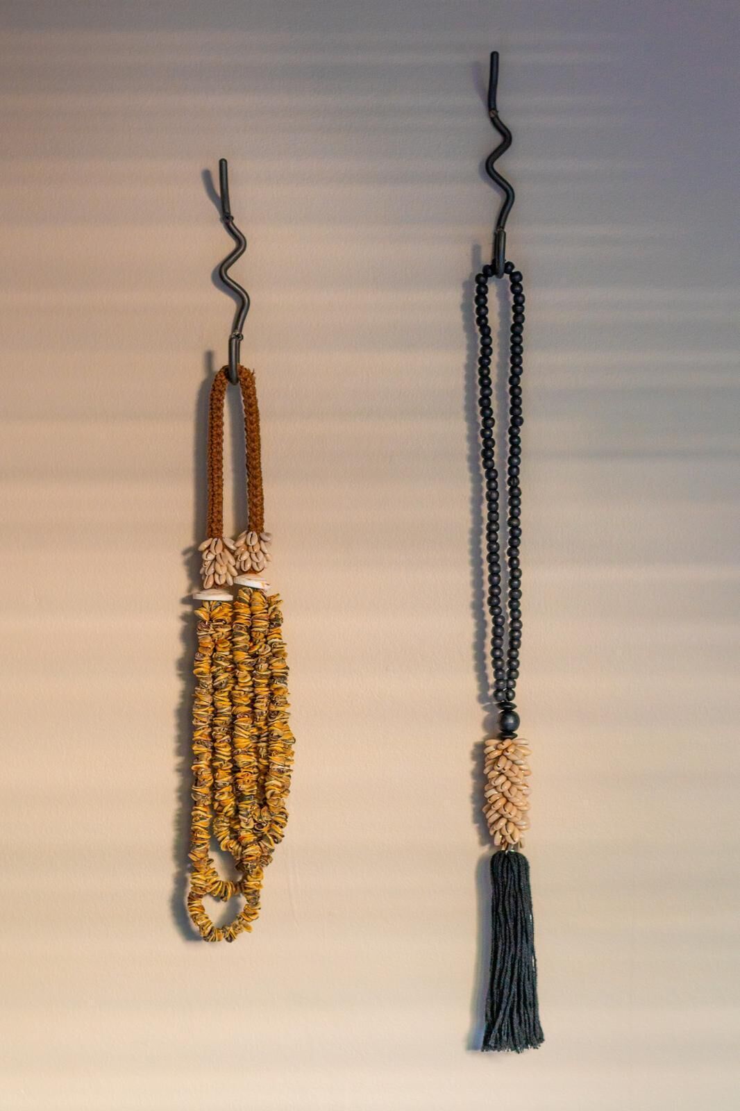 Two necklaces with tassels and beads.