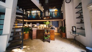 A kitchen with a wooden staircase, a coffee machine, and potted plants. - 8aps-4 Luxury House in the Historic Center With Pool Air Conditioning and Wifi (Cartagena)