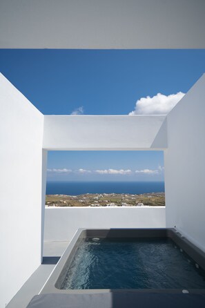 Un jacuzzi con vista al océano y un cielo despejado.