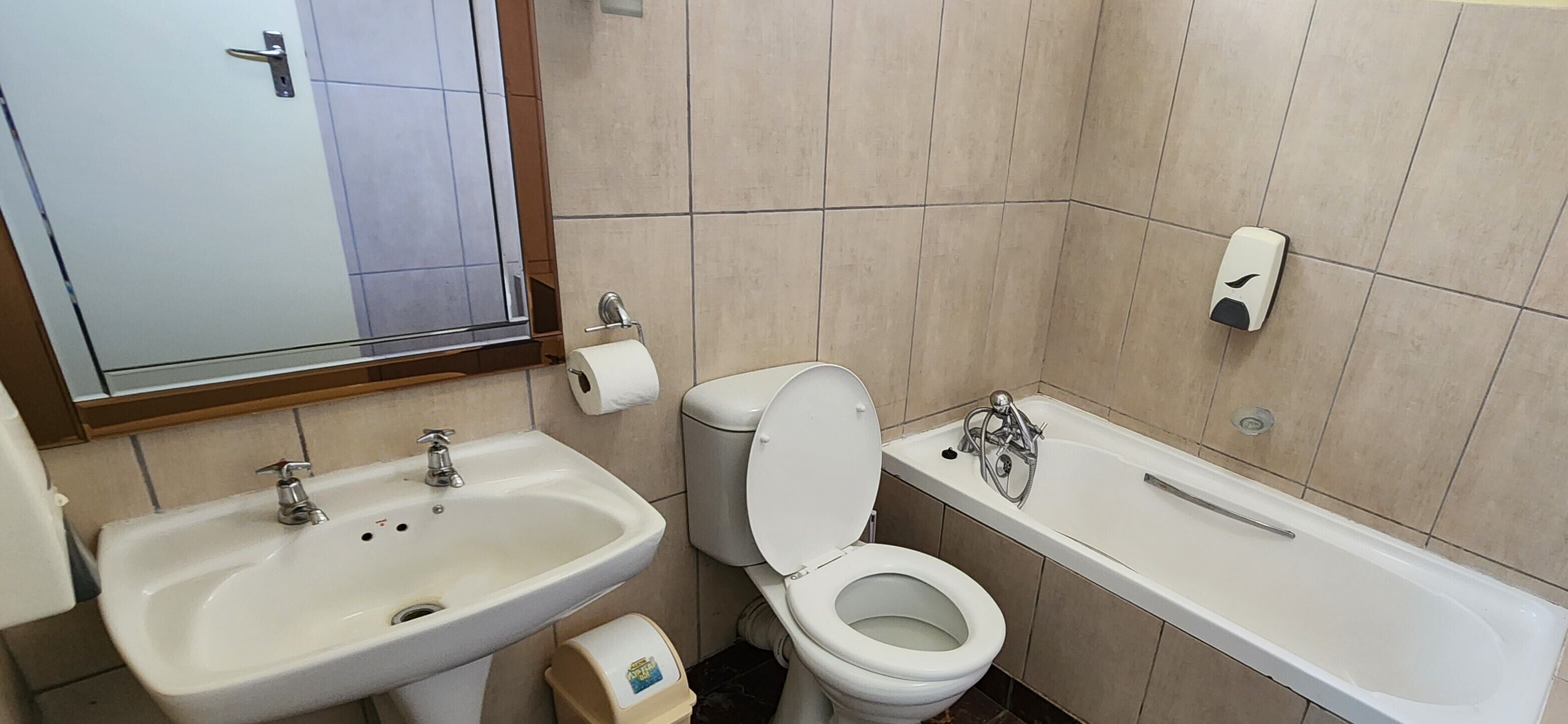 A bathroom with a sink, toilet, and bathtub.