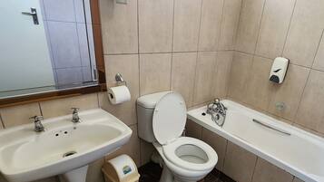A bathroom with a sink, toilet, and bathtub.