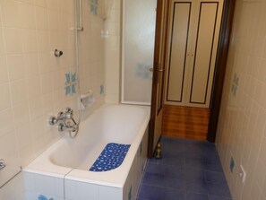 Ein Badezimmer mit Badewanne, Dusche und Toilette.