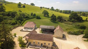 A rural property with a large stone building, a smaller house, and a barn. - Luxury 2-Bed Cotswolds Barn with Private Hot Tub | Sleeps 4 (Gloucester)