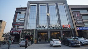 A hotel with a modern facade, a prominent sign for 'Hotel Aparitia', and a 'Barista' sign indicating a coffee shop. - Hotel Apricia  (Ludhiana)