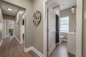 Bathtub, hair dryer, towels, toilet paper